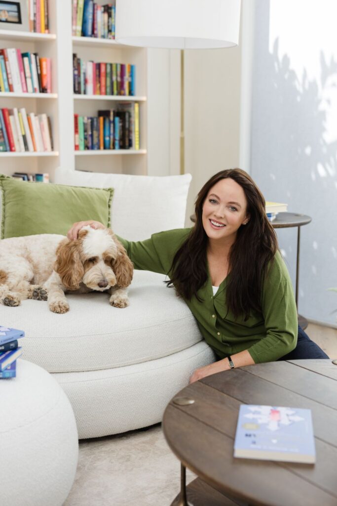 Michelle smiling stroking her dog