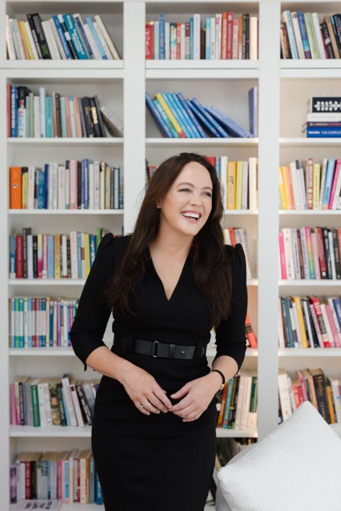 Michelle standing smiling near her books